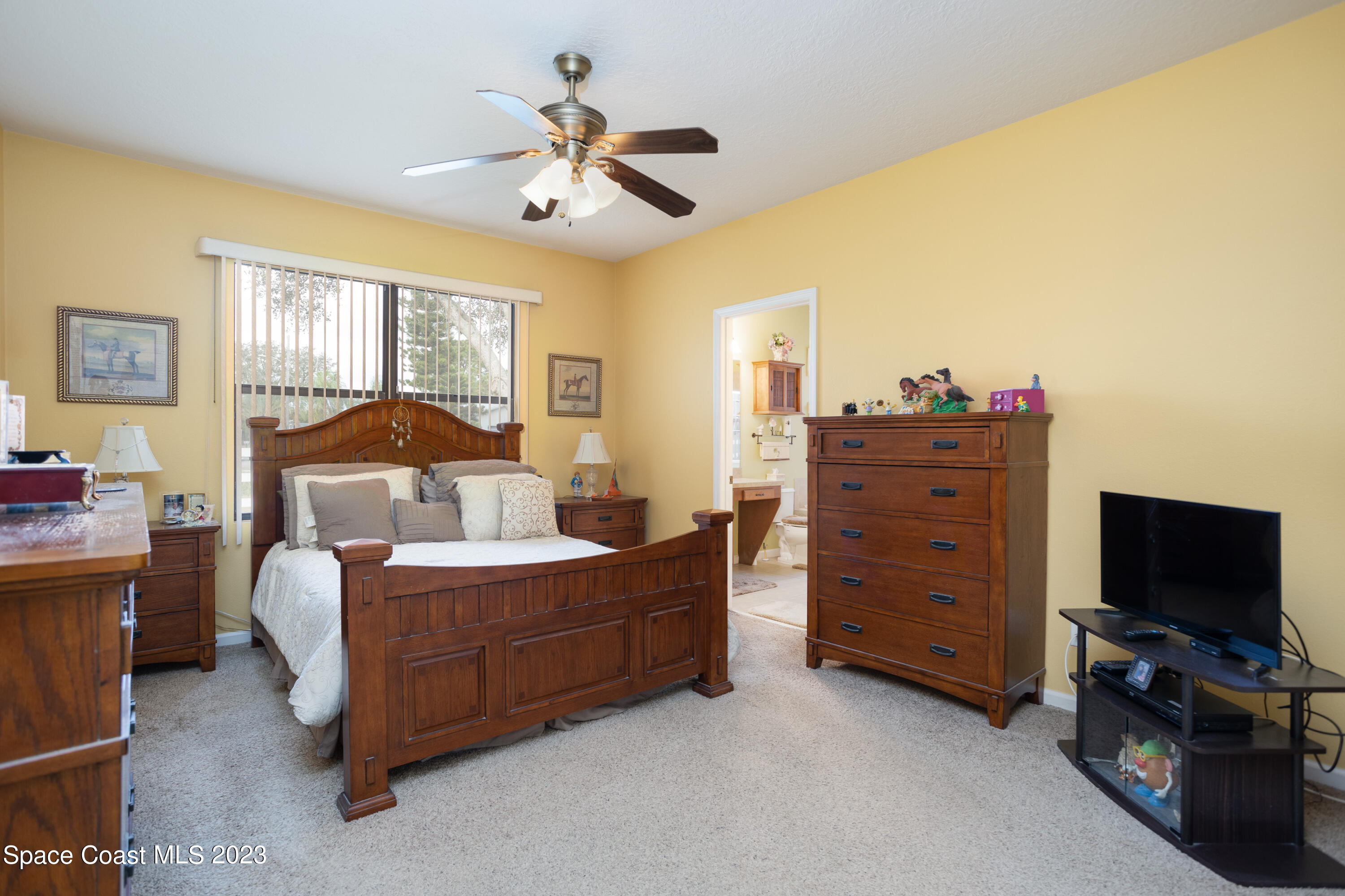 4130 Millicent Circle Melbourne, FL 32901 - Photo 16 of 28 a living room with furniture and a flat screen tv