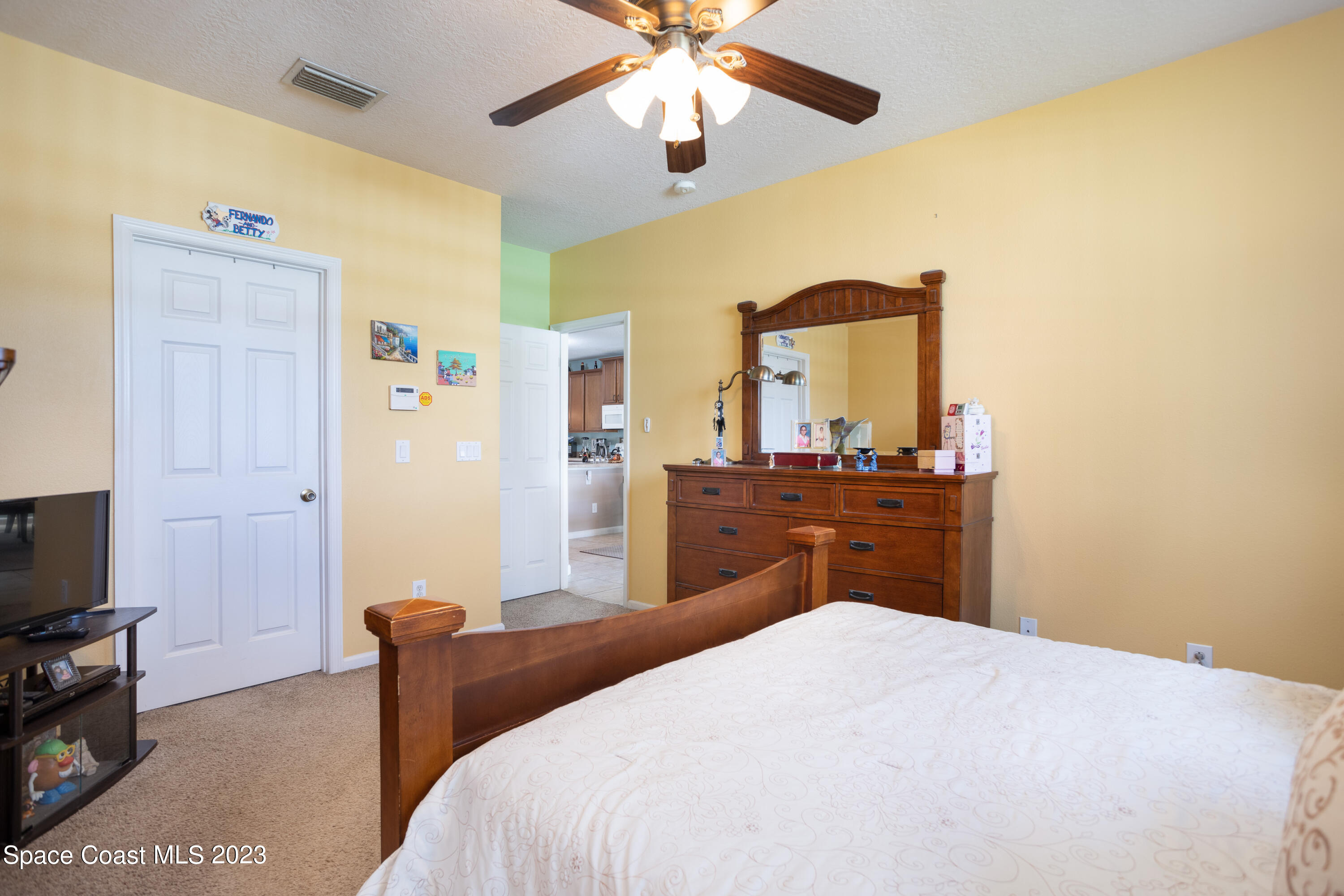 4130 Millicent Circle Melbourne, FL 32901 - Photo 17 of 28 a bedroom with a bed and a flat screen tv