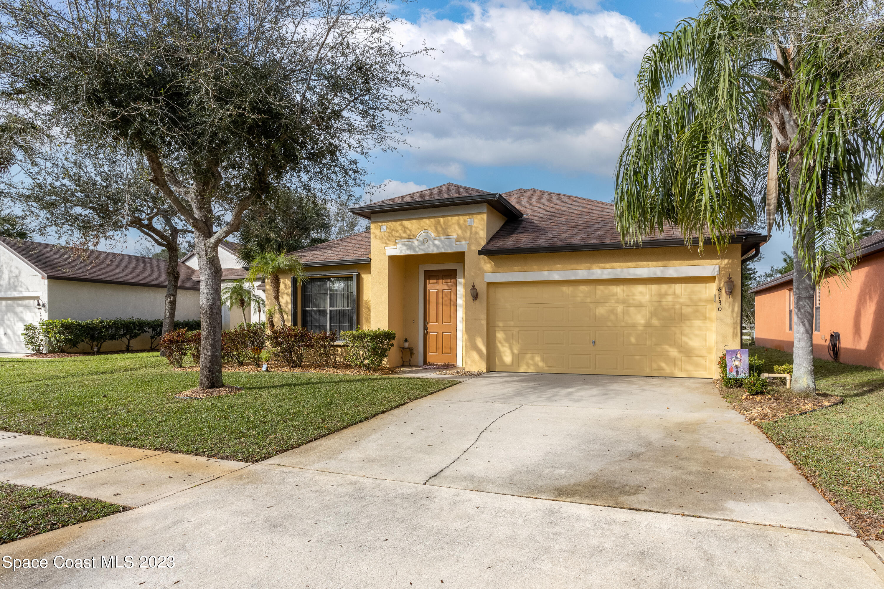 4130 Millicent Circle Melbourne, FL 32901 - Photo 2 of 28 a view of a house with a yard and potted plants