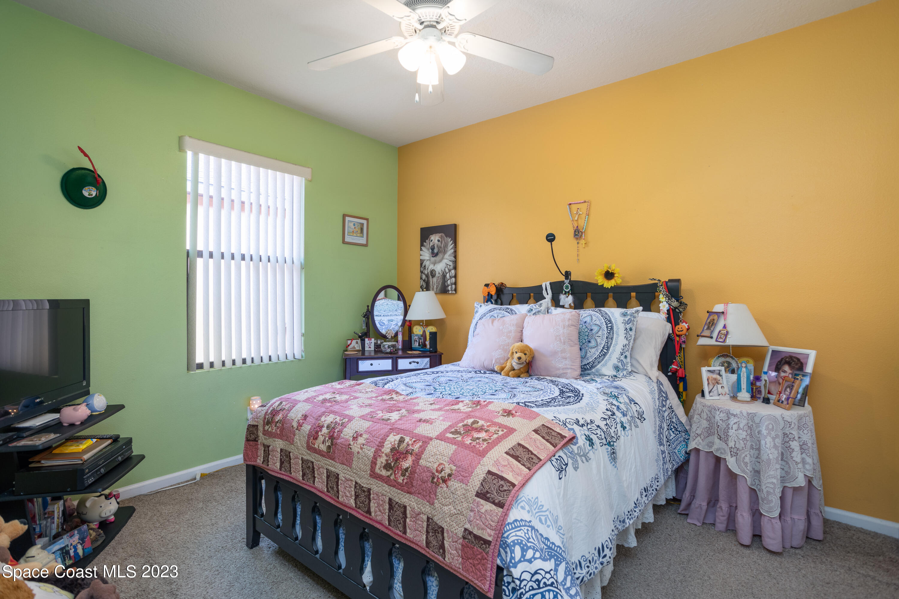 4130 Millicent Circle Melbourne, FL 32901 - Photo 21 of 28 a bedroom with a bed and a chandelier