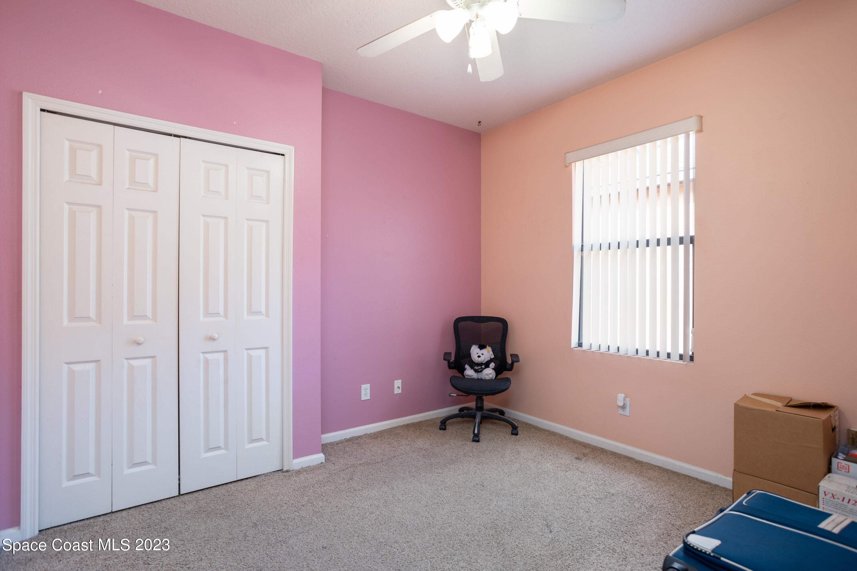4130 Millicent Circle Melbourne, FL 32901 - Photo 22 of 28 an empty room with windows and ceiling fan