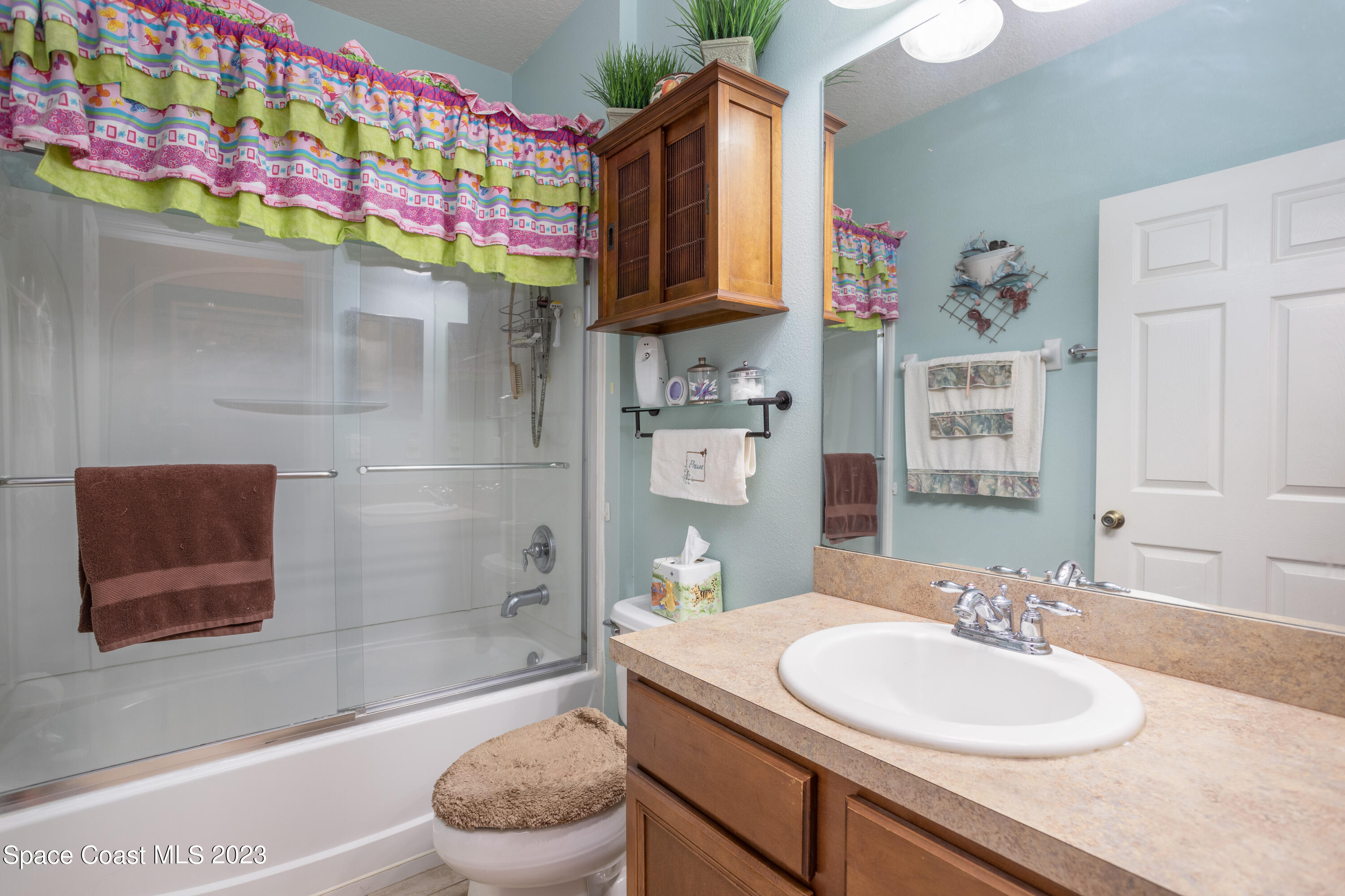 4130 Millicent Circle Melbourne, FL 32901 - Photo 23 of 28 a bathroom with a sink a toilet and shower