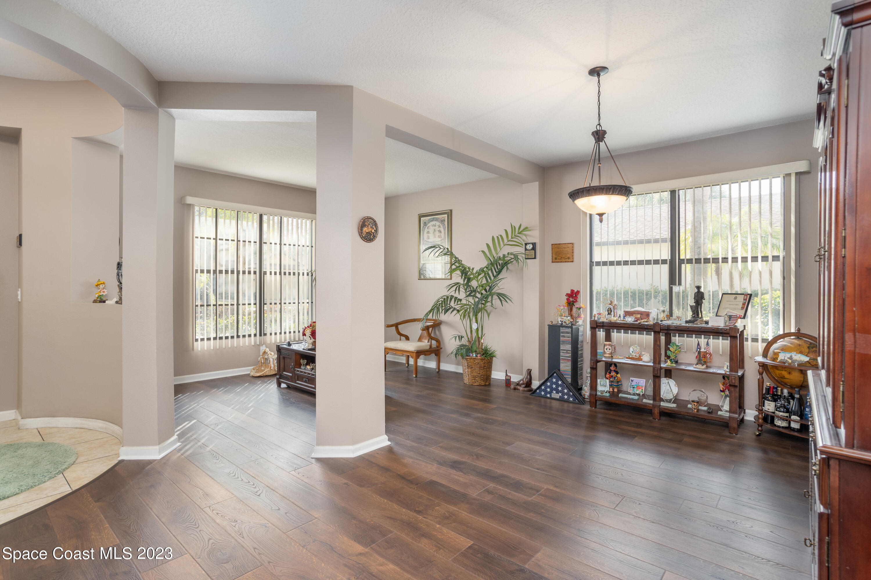 4130 Millicent Circle Melbourne, FL 32901 - Photo 5 of 28 a view of an empty room with window and wooden floor