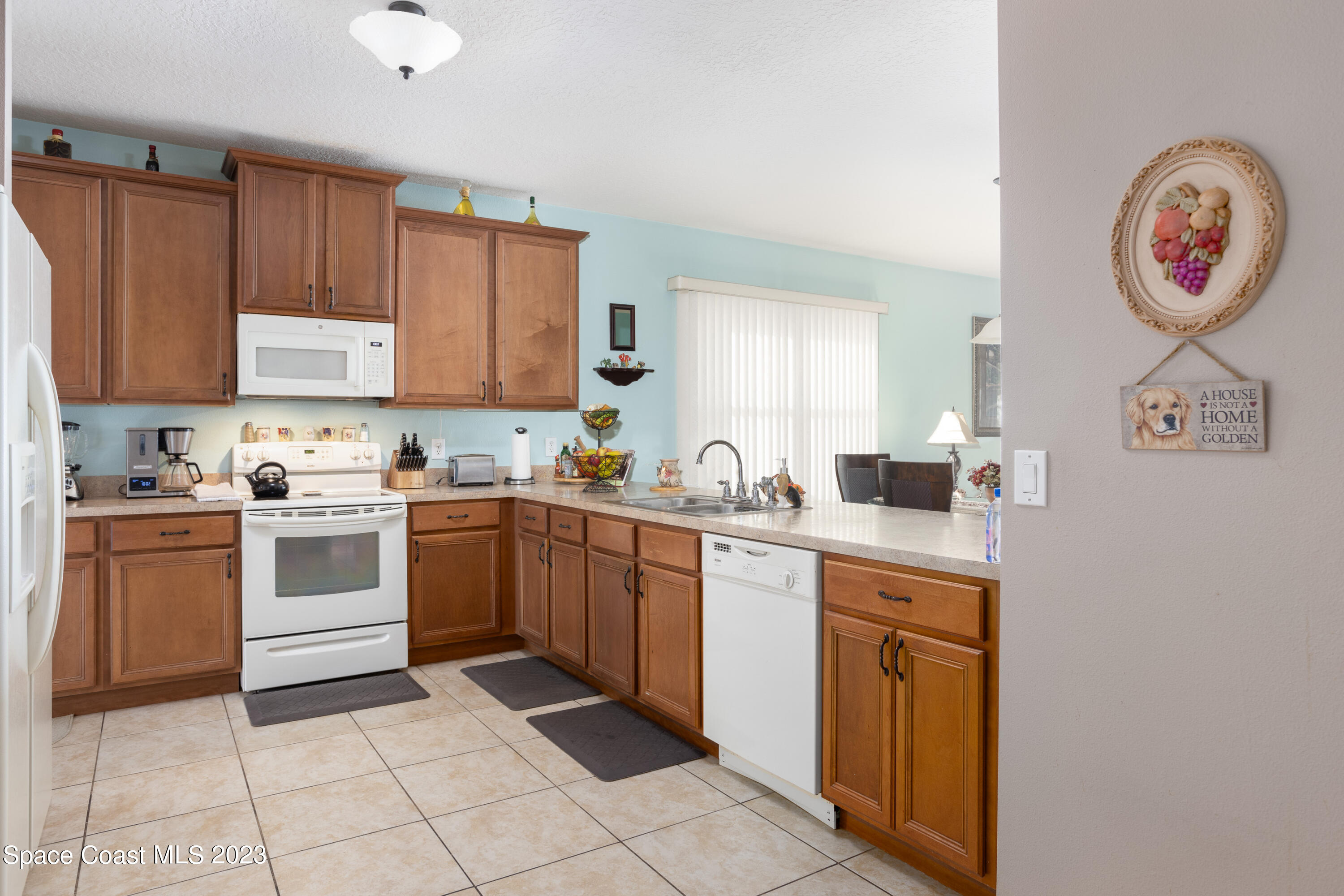 4130 Millicent Circle Melbourne, FL 32901 - Photo 9 of 28 a kitchen with a cabinets and a stove
