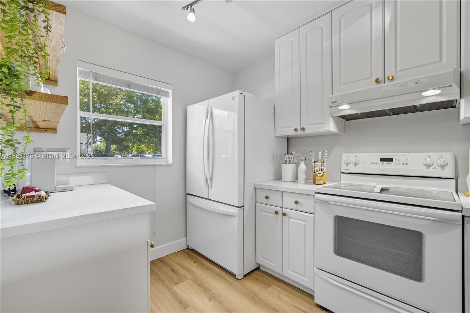 1501 South Ocean Boulevard, Unit 117 Lauderdale-by-the-Sea, FL 33062 - Photo 14 of 38 a kitchen with appliances cabinets and a sink