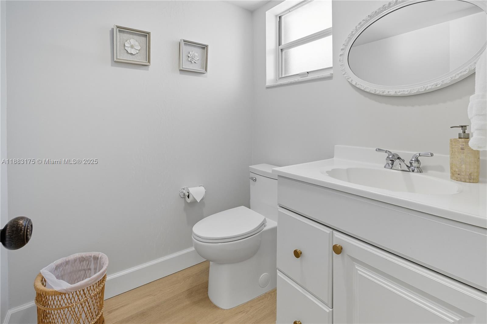 1501 South Ocean Boulevard, Unit 117 Lauderdale-by-the-Sea, FL 33062 - Photo 19 of 38 a bathroom with a sink toilet and a mirror