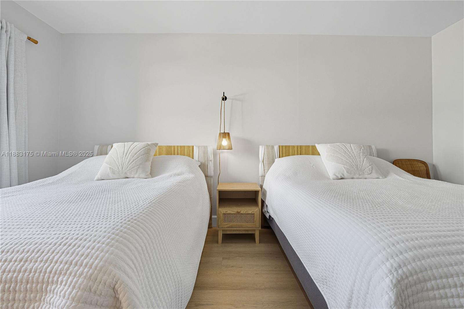 1501 South Ocean Boulevard, Unit 117 Lauderdale-by-the-Sea, FL 33062 - Photo 23 of 38 a bedroom with two beds and painted walls