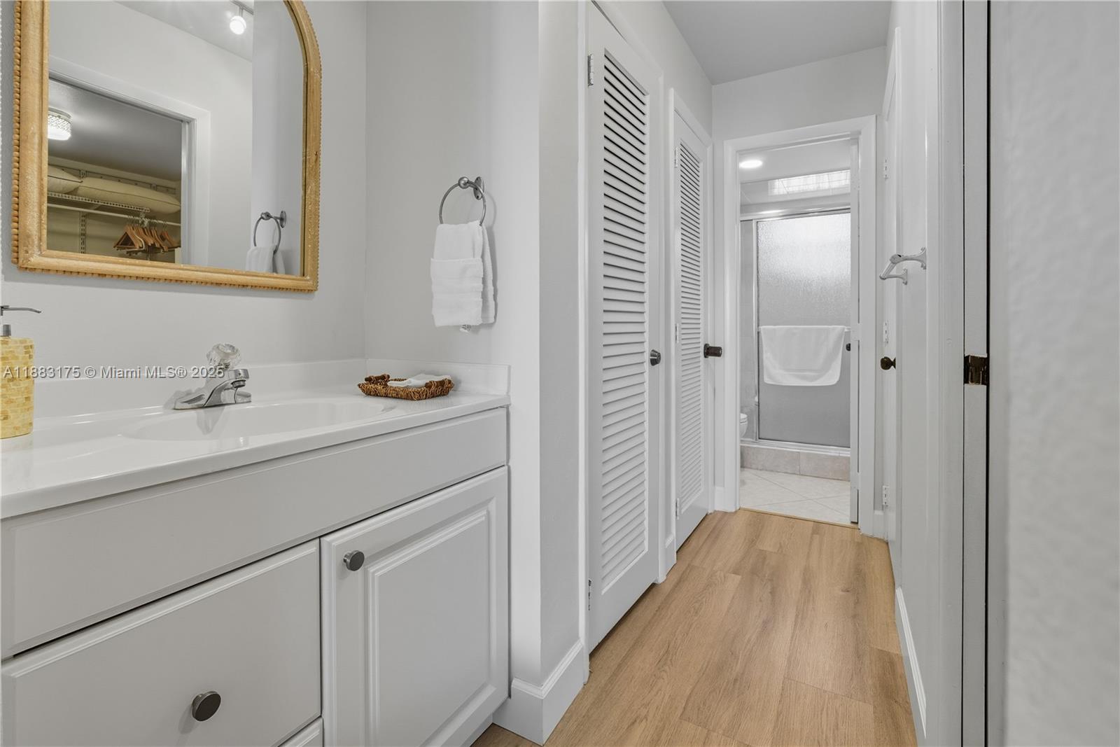 1501 South Ocean Boulevard, Unit 117 Lauderdale-by-the-Sea, FL 33062 - Photo 25 of 38 a bathroom with a sink and a mirror