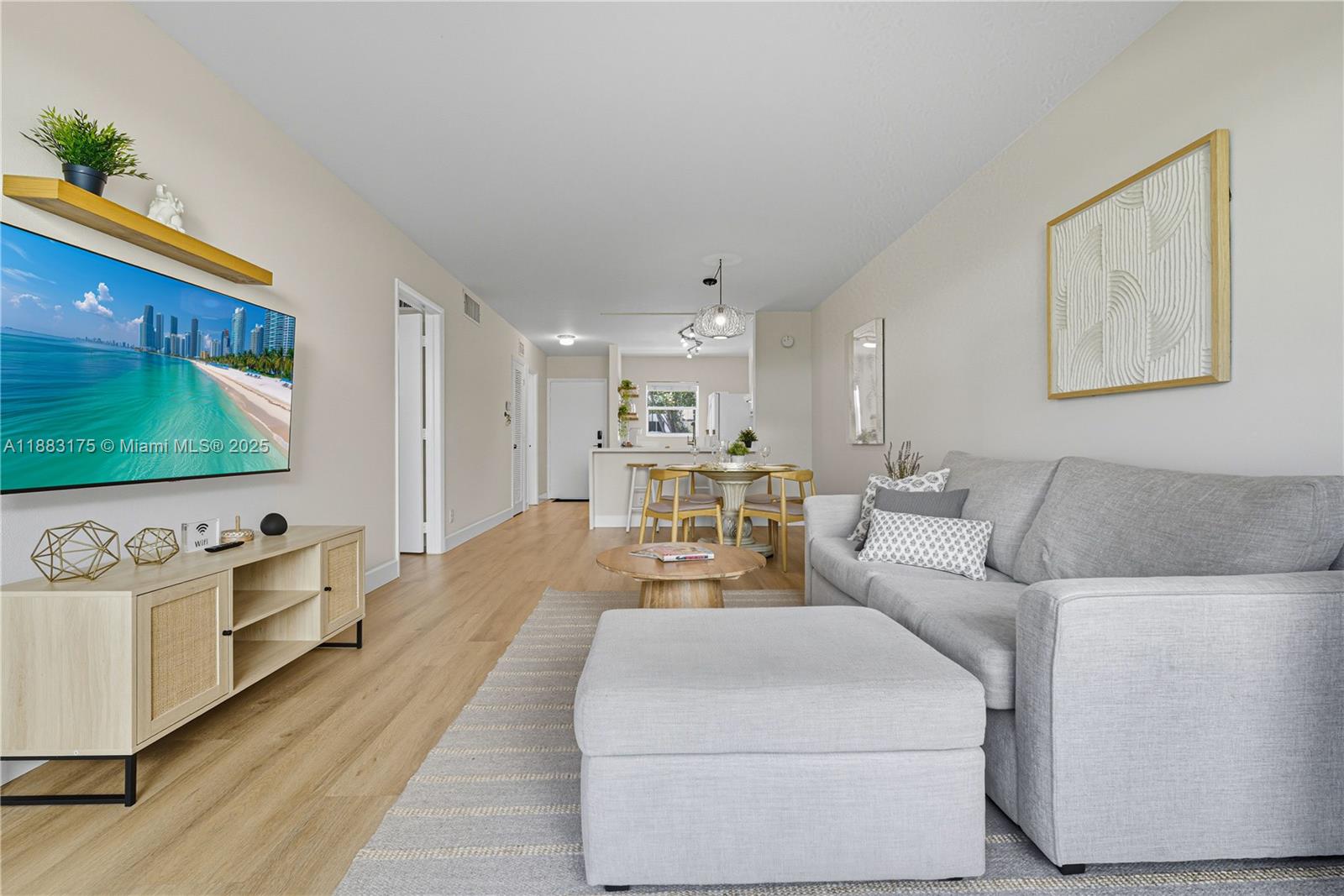 1501 South Ocean Boulevard, Unit 117 Lauderdale-by-the-Sea, FL 33062 - Photo 7 of 38 a living room with furniture and a flat screen tv