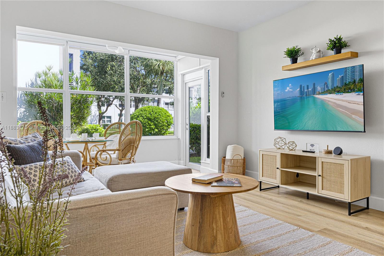 1501 South Ocean Boulevard, Unit 117 Lauderdale-by-the-Sea, FL 33062 - Photo 8 of 38 a living room with furniture and a flat screen tv