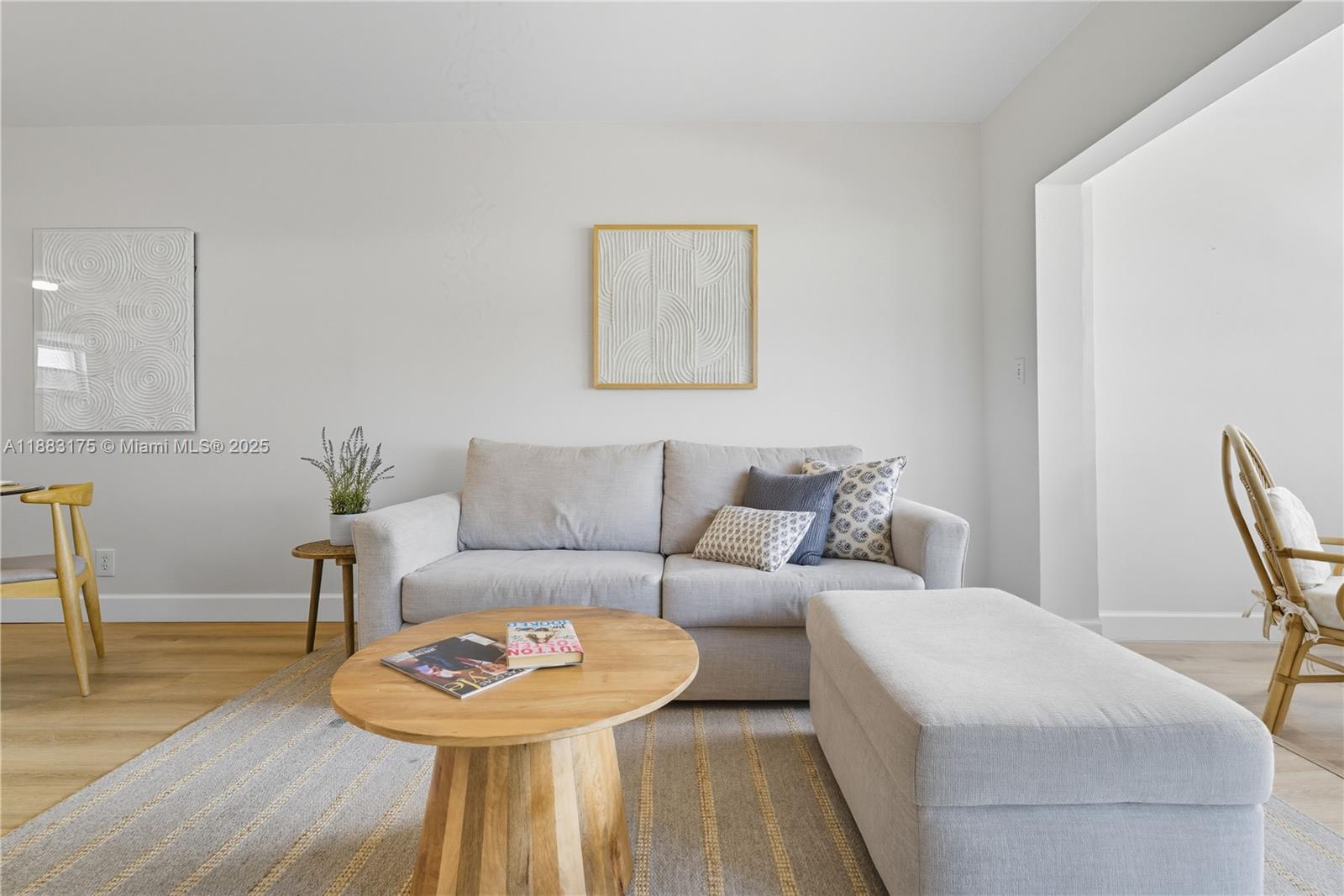 1501 South Ocean Boulevard, Unit 117 Lauderdale-by-the-Sea, FL 33062 - Photo 9 of 38 a living room with furniture and a wooden floor