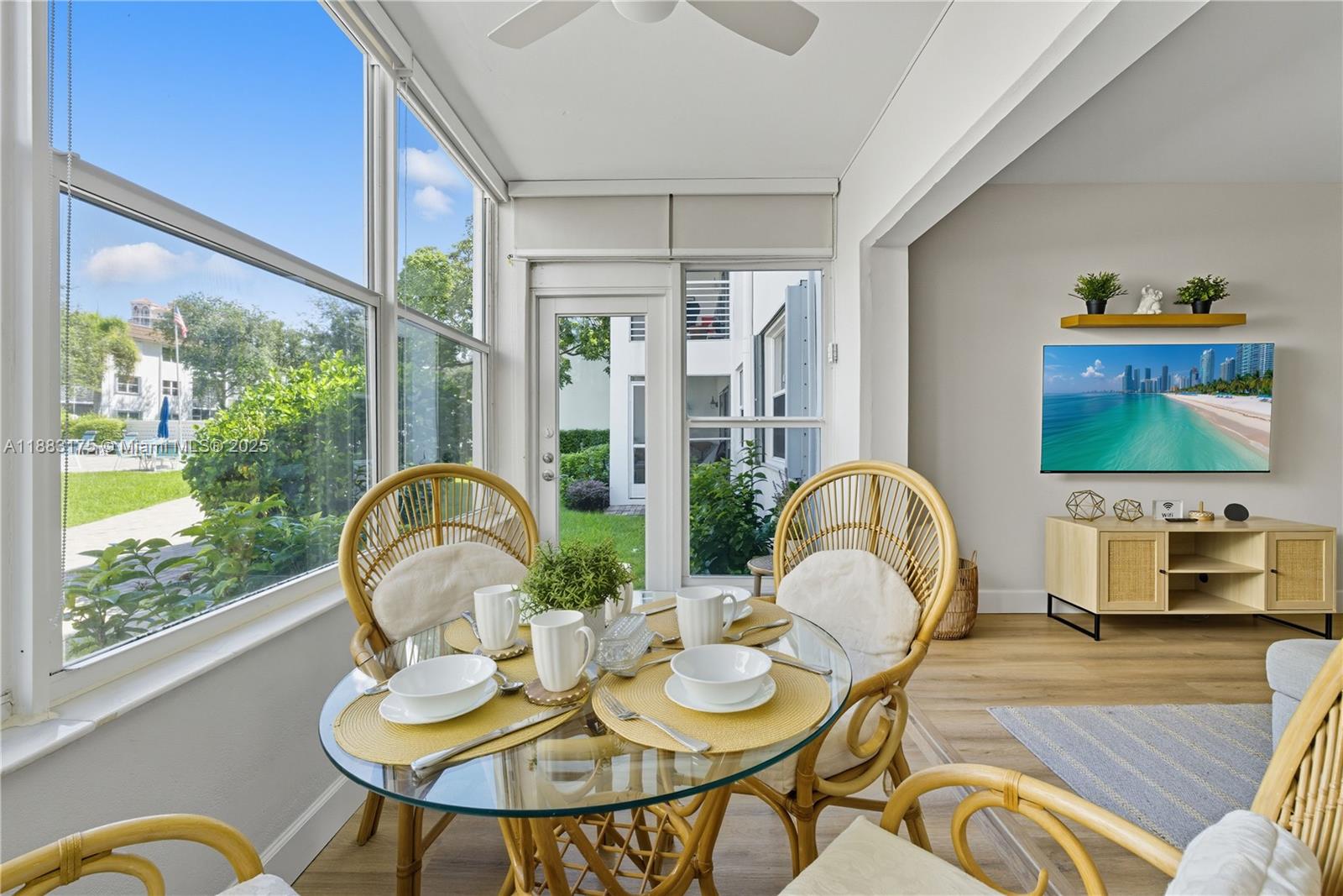 1501 South Ocean Boulevard, Unit 117 Lauderdale-by-the-Sea, FL 33062 - Photo 10 of 38 a living room with couches a dining table and a fireplace with wooden floor