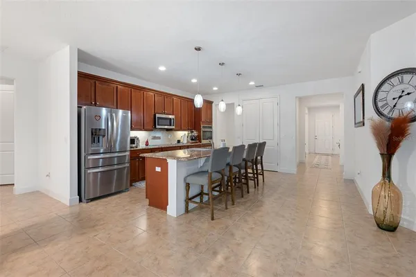 a kitchen with stainless steel appliances granite countertop a sink stove and microwave