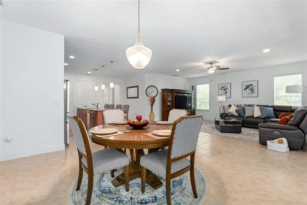 a living room with furniture a flat screen tv and a window