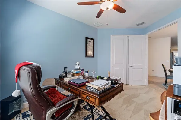 a bedroom with a bed and ceiling fan