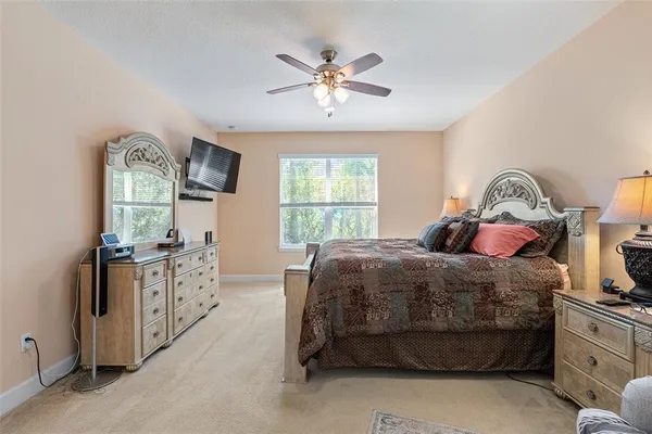 a spacious bathroom with a tub sink shower and mirror