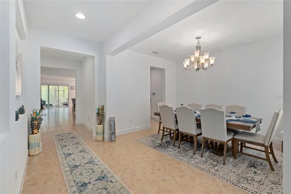 a dining room with furniture and chandelier