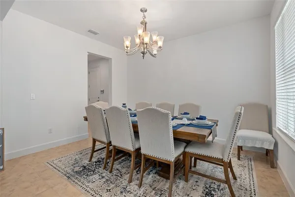 a dining room with furniture and window