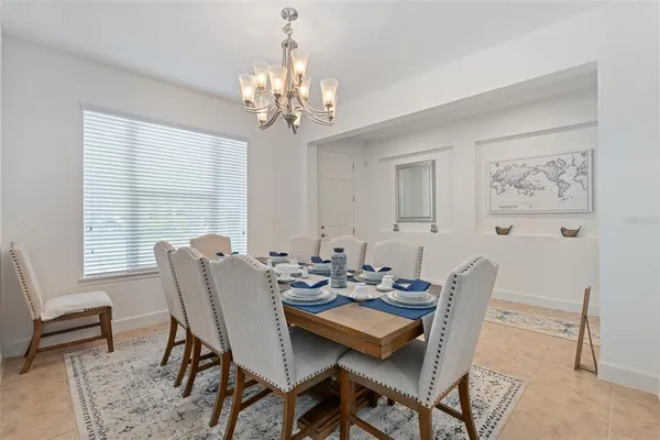 a view of a hallway with a view of living room with a wooden floor