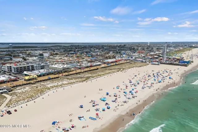 a bedroom with a large bed and a large window with outer view