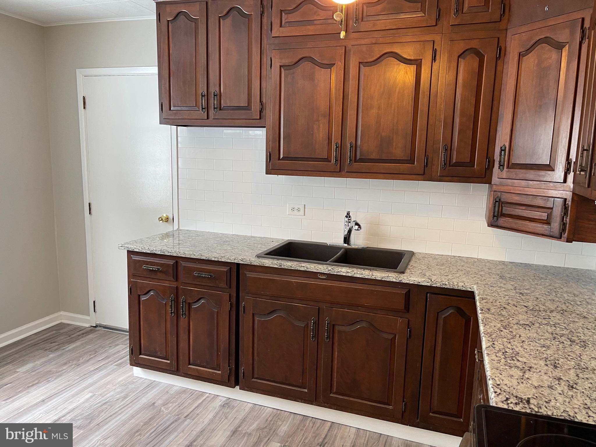 135 Garrett Road Newark, DE 19713 - Photo 14 of 32 a kitchen with wooden cabinets and a sink