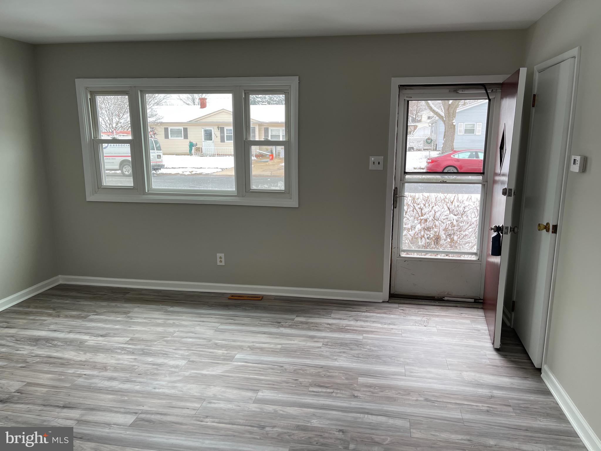 135 Garrett Road Newark, DE 19713 - Photo 6 of 32 a view of an empty room with wooden floor and a window