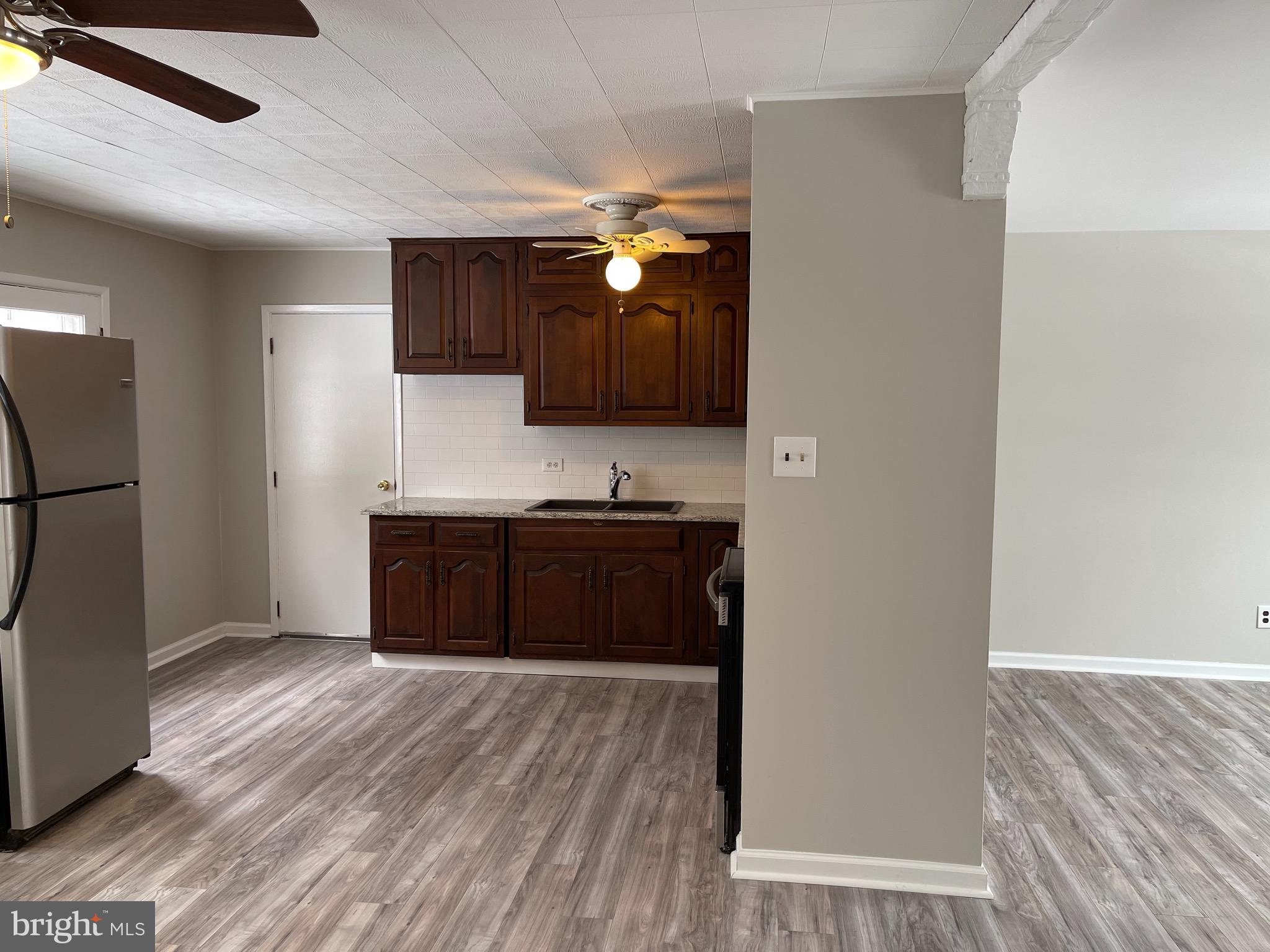 135 Garrett Road Newark, DE 19713 - Photo 8 of 32 a kitchen with a refrigerator and a stove top oven
