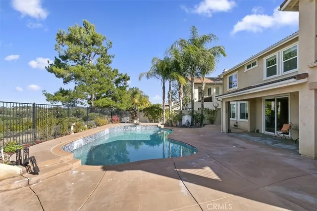 a view of a swimming pool with a yard
