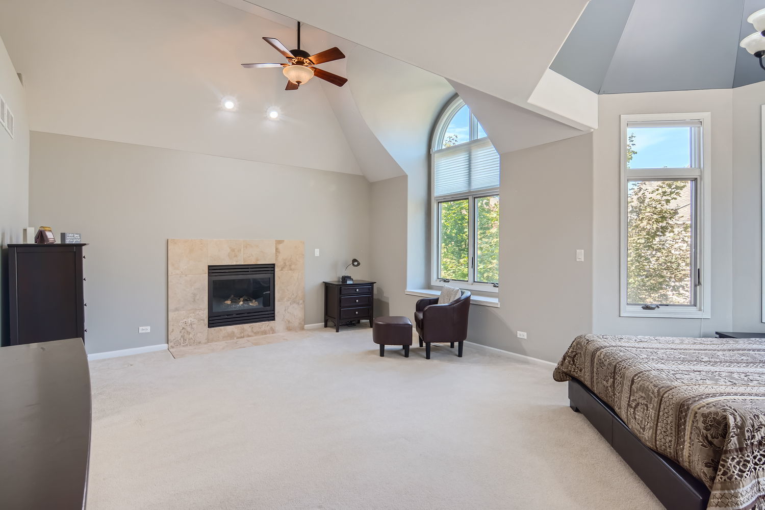 1419 Rue Paris Place Inverness, IL 60067 - Photo 16 of 28 a spacious bedroom with a bed and a chandelier