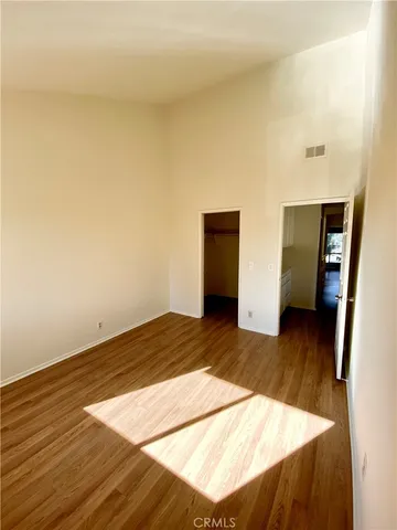 a view of a room with wooden floor and bedroom