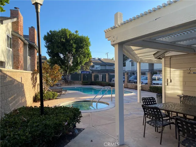 a view of a house with backyard and sitting area