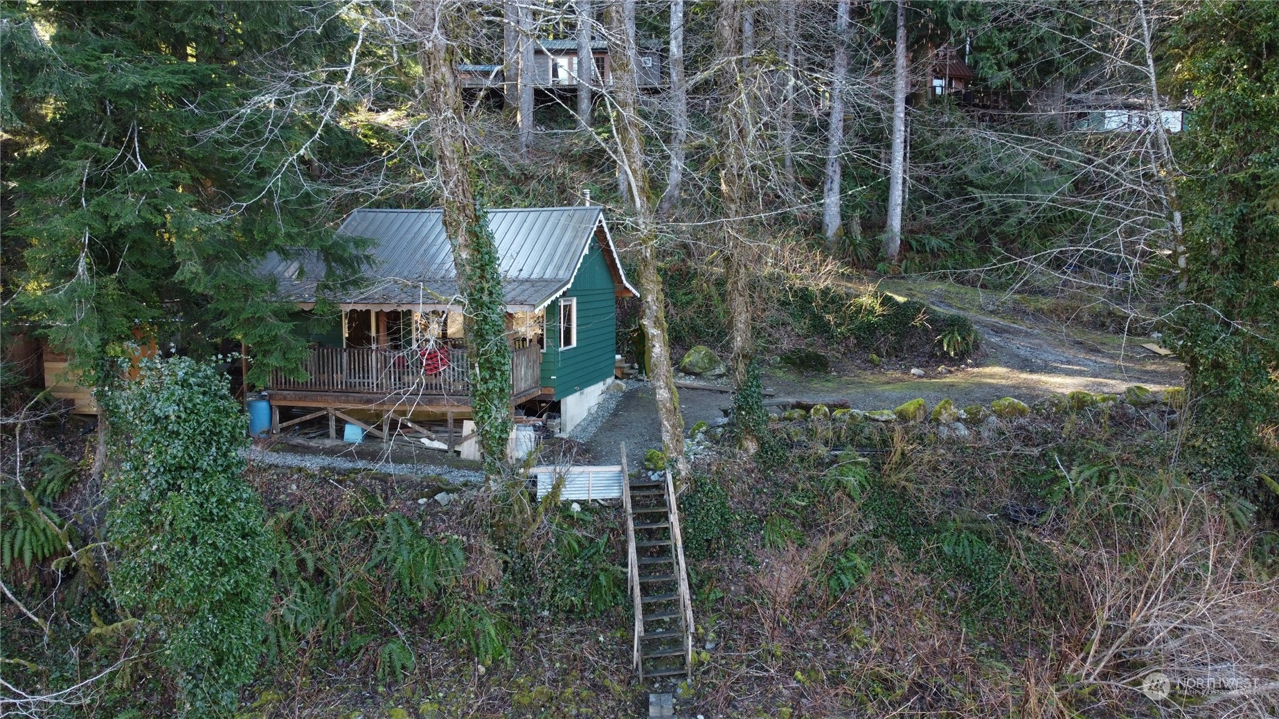 51903 South Riverside Road Gold Bar, WA 98251 - Photo 1 of 2 a aerial view of a house with a yard and large trees