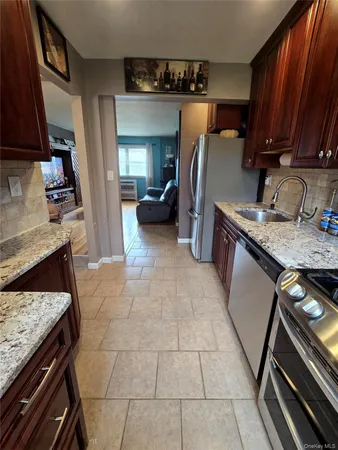 a kitchen with a sink a stove and a refrigerator