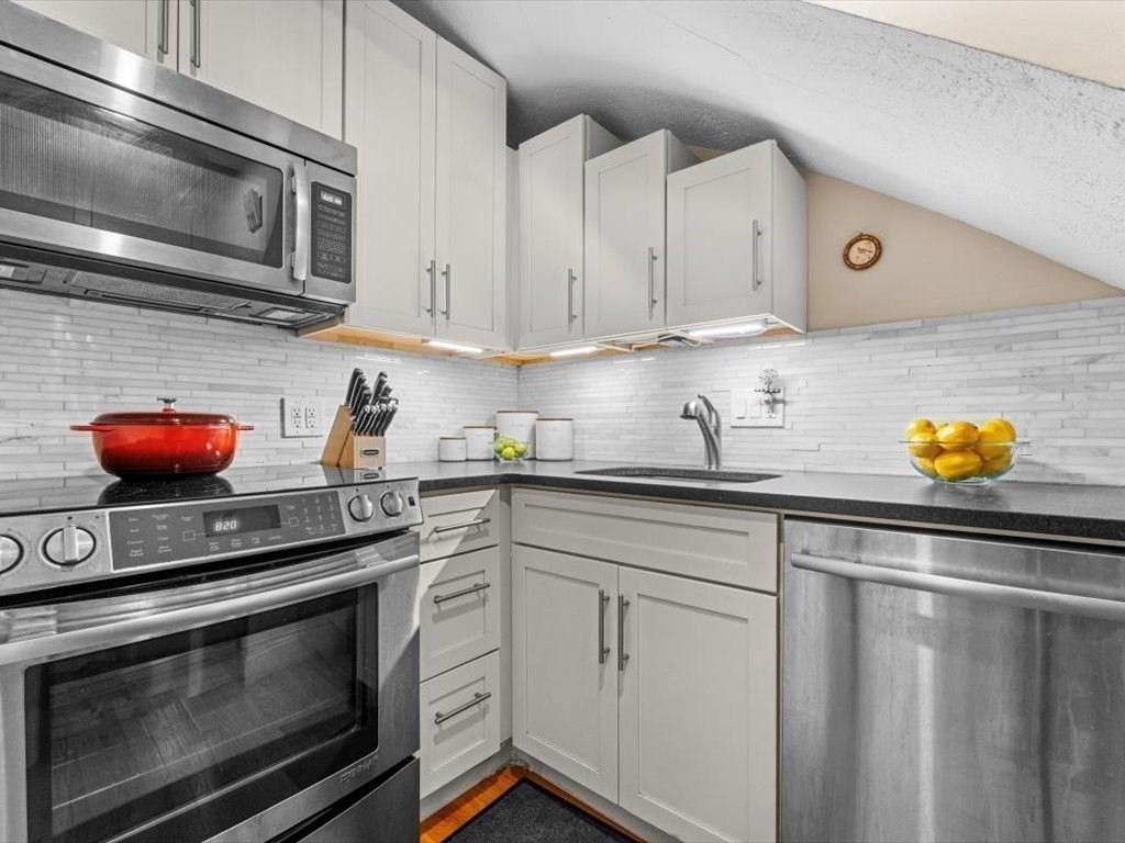 103 Appleton Street, Unit 3 Boston, MA 02116 - Photo 11 of 24 a kitchen with stainless steel appliances granite countertop a sink and a stove