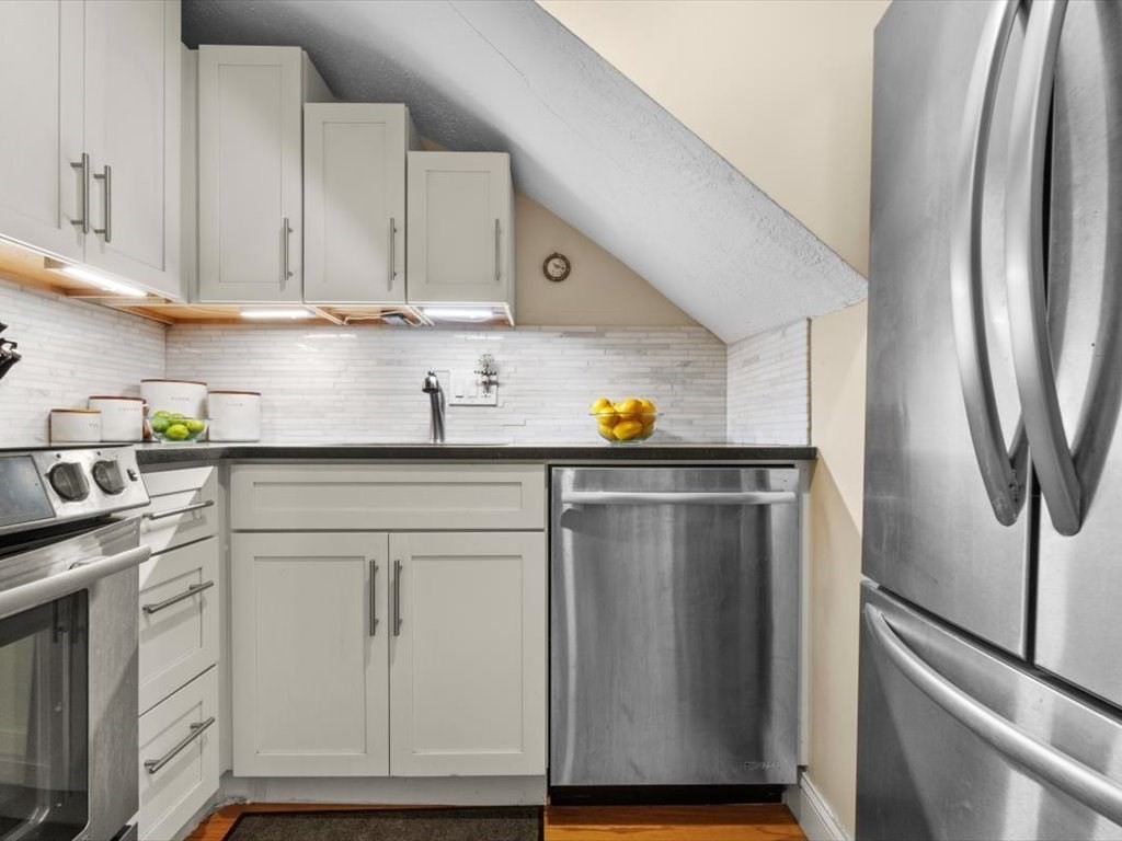 103 Appleton Street, Unit 3 Boston, MA 02116 - Photo 12 of 24 a kitchen with stainless steel appliances granite countertop a refrigerator sink and cabinets