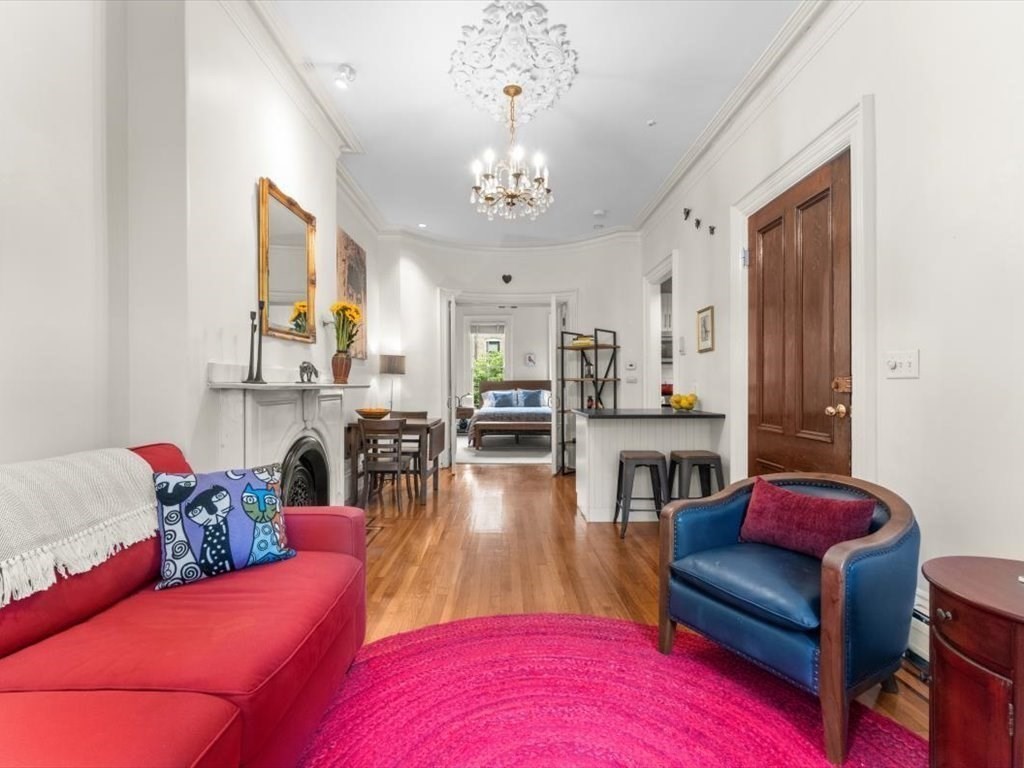 103 Appleton Street, Unit 3 Boston, MA 02116 - Photo 2 of 24 a living room with furniture dining table and a chandelier