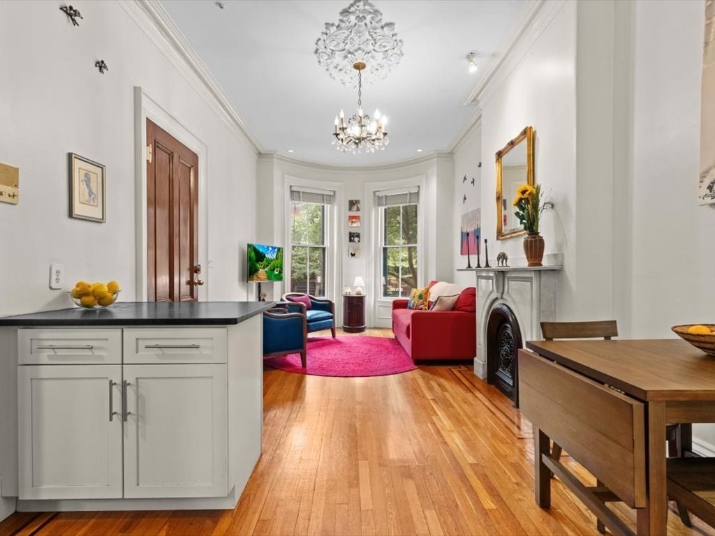 103 Appleton Street, Unit 3 Boston, MA 02116 - Photo 5 of 24 a bedroom with furniture and a chandelier