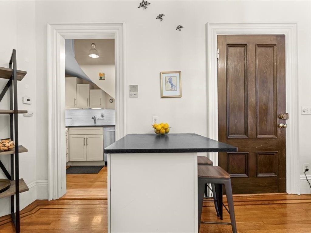 103 Appleton Street, Unit 3 Boston, MA 02116 - Photo 10 of 24 a kitchen view with wooden floor and cabinets