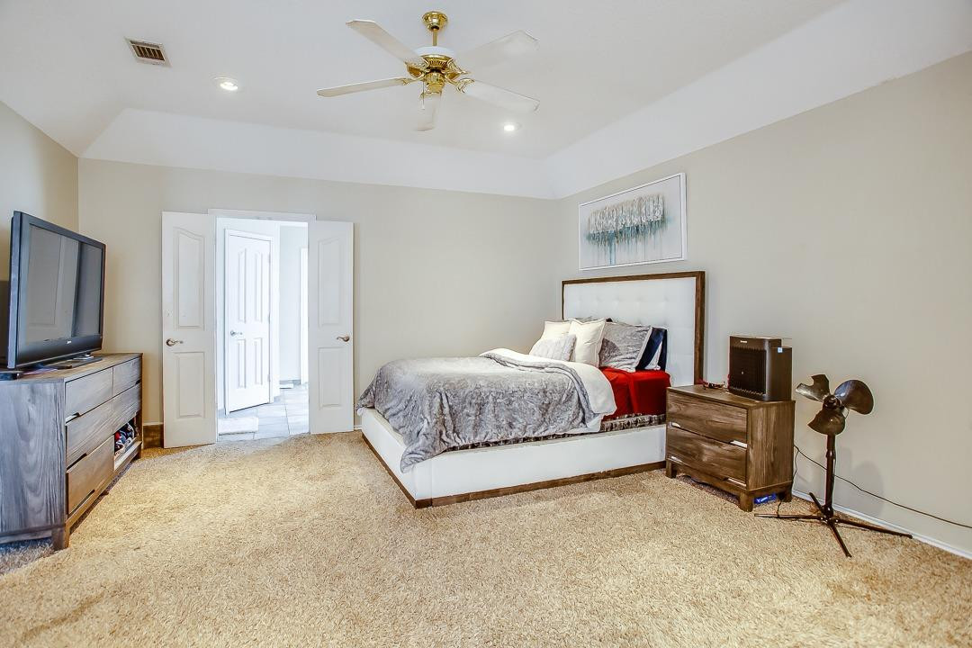 6032 79th Street Lubbock, TX 79424 - Photo 11 of 19 a bedroom with a bed and furniture