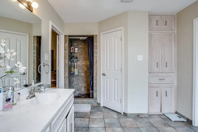 a spacious bathroom with a tub shower and sink