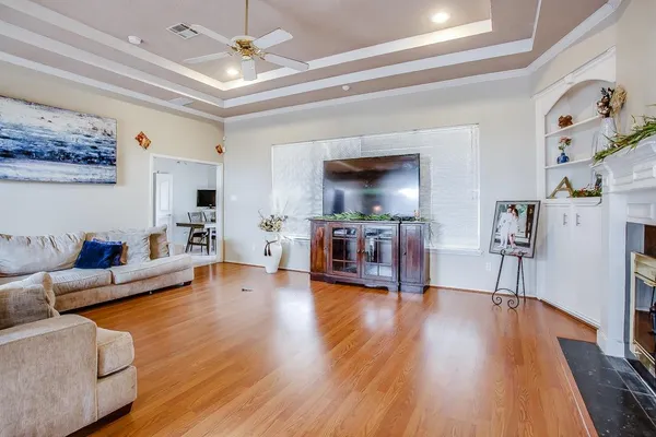 a living room with furniture and a wooden floor