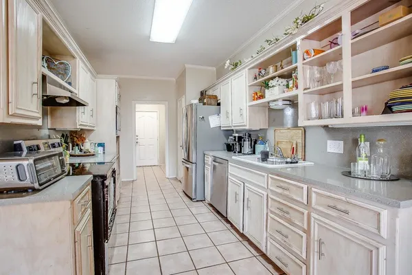 a kitchen with stainless steel appliances granite countertop a stove a sink and a refrigerator