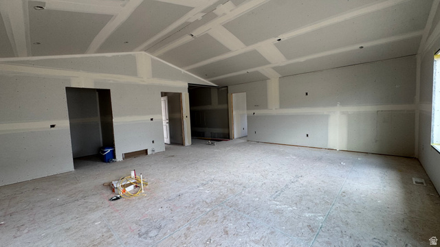 1862 Mantle Way, Unit 418 Tooele, UT 84074 - Photo 9 of 10 Expansive interior space featuring vaulted ceilings and unfinished drywall