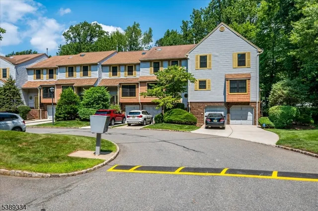 a aerial view of a house with swimming pool and a yard