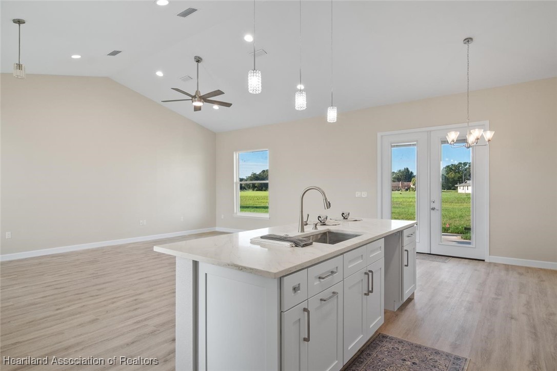 8300 Granada Road Sebring, FL 33876 - Photo 8 of 50 KITCHEN AND LIVING ROOM. FRENCH DOORS TO BACK YARD