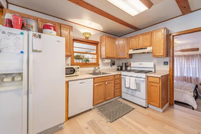 a kitchen with white cabinets and white appliances