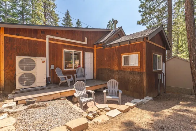 a view of a house with backyard and sitting area