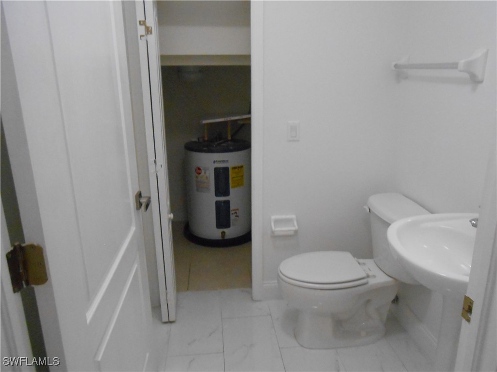 9409 Ivy Brook Run, Unit 1303 Fort Myers, FL 33913 - Photo 11 of 25 a white toilet sitting next to a sink