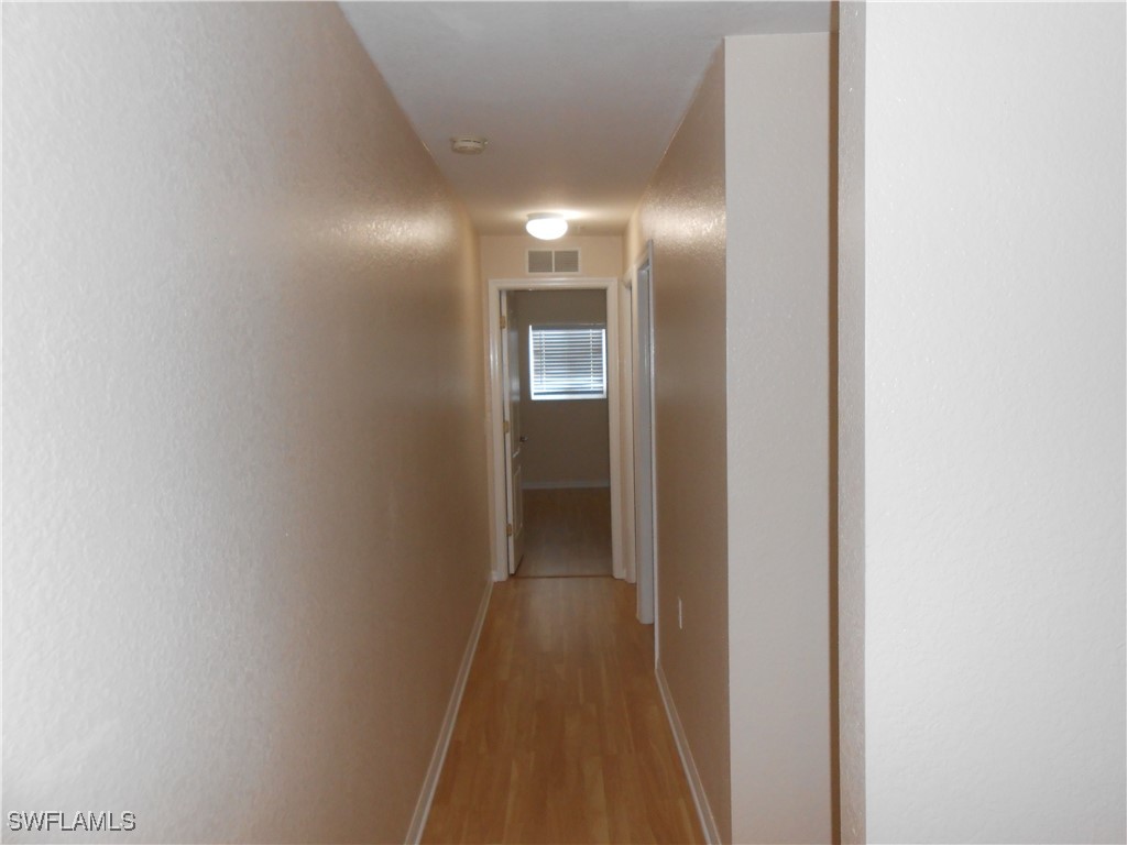 9409 Ivy Brook Run, Unit 1303 Fort Myers, FL 33913 - Photo 18 of 25 a view of hallway with stairs