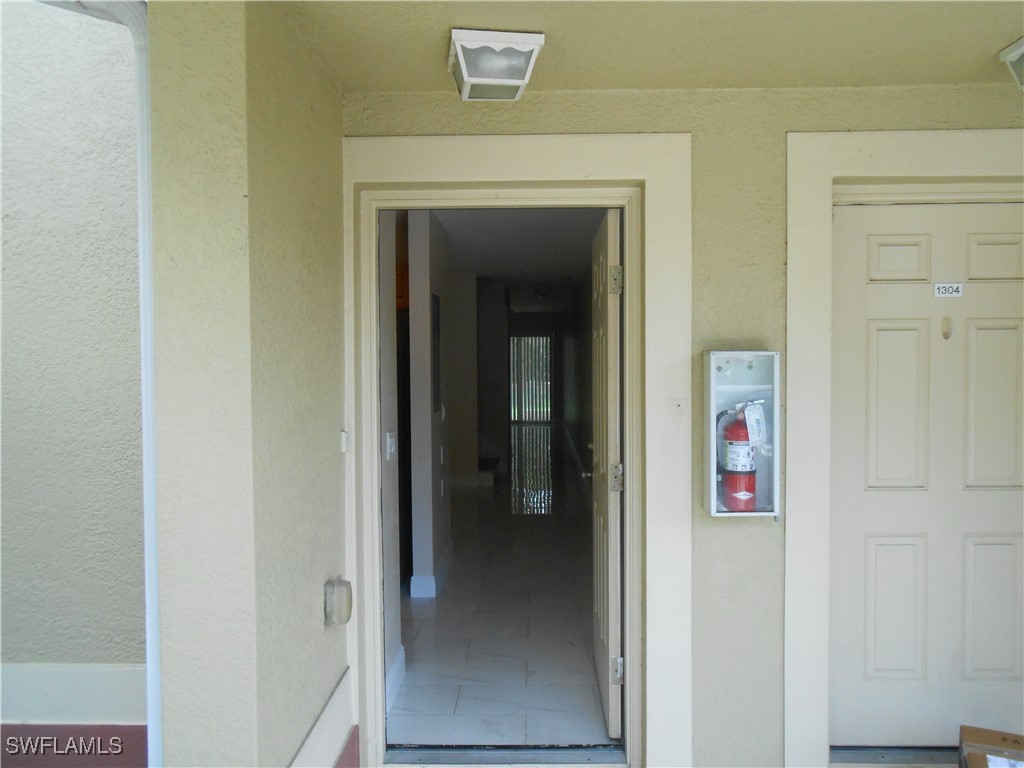 9409 Ivy Brook Run, Unit 1303 Fort Myers, FL 33913 - Photo 2 of 25 a view of a hallway with wooden floor